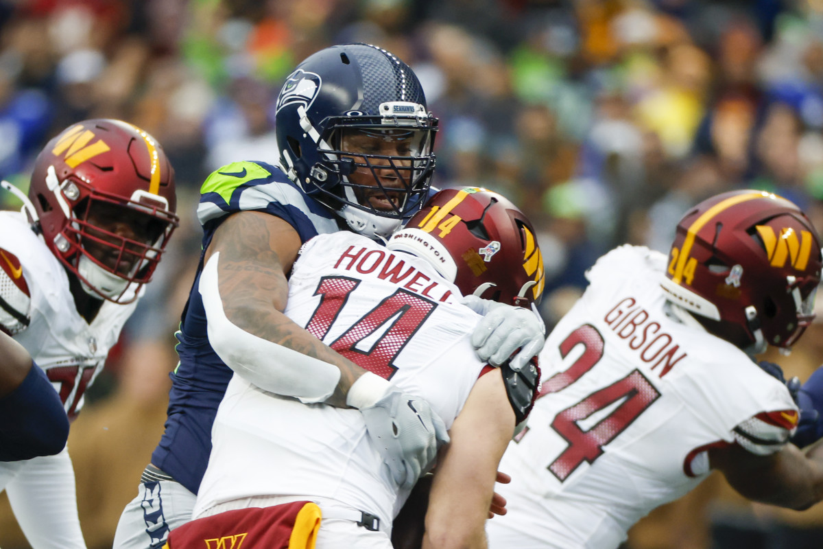 Seattle Seahawks defensive end Leonard Williams (99) sacks Washington Commanders quarterback Sam Howell (14) during the second quarter at Lumen Field.